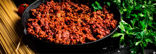 istock Frying pan with bolognese sauce on the table. 1463898766