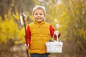 Cute preschool child, boy, holding handmade braided whip made from pussy willow, traditional symbol of Czech Easter used for whipping girls to receive eggs and sweets