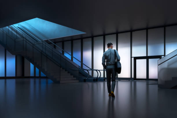 istock Young businessman leaving the office building at night 1463902508