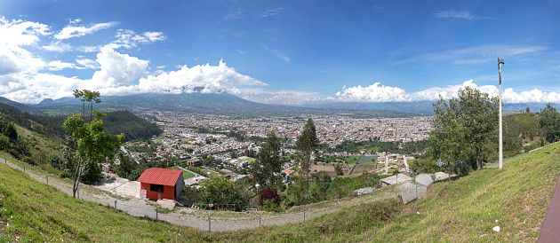 Panoramic view of the city of Ibarra, Yahuarcocha lake and surrounding Andean mountains and forests. Ibarra, Imbabura Province, Ecuador