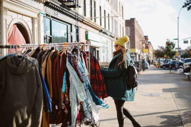 istock woman browsing clothes through an open market in NY 1463906843
