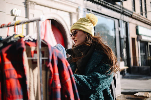 istock woman browsing clothes through an open market in NY 1463906891