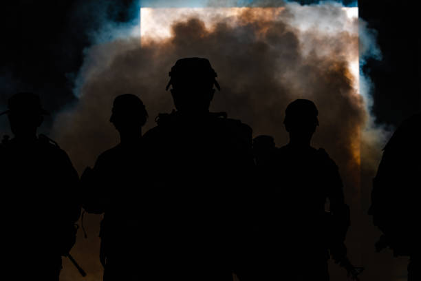 istock silhouette thai soldiers special forces team full uniform walking action through smoke and holding gun on hand 1463925491