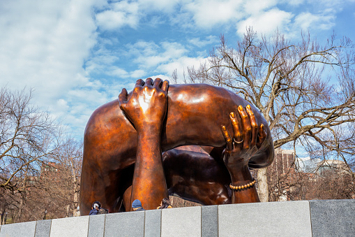 Boston, Massachusetts, USA - February 5, 2023: The Embrace is a bronze sculpture by Hank Willis Thomas, installed on Boston Common in Boston, Massachusetts, in December 2022. The artwork commemorates Martin Luther King Jr. and Coretta Scott King, and depicts four intertwined arms, representing the hug they shared after he was awarded the Nobel Peace Prize in 1964.