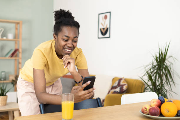 istock Young African woman making a video call at home 1463937488