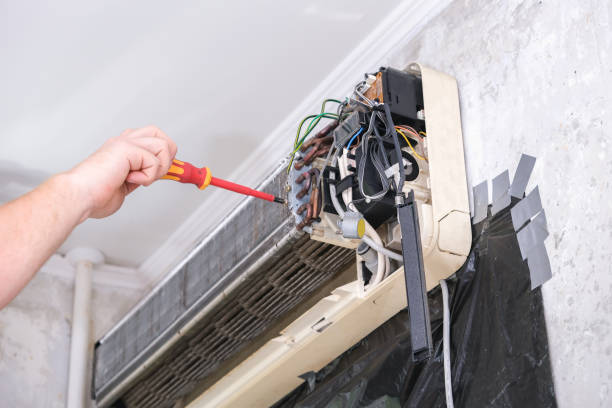 istock man disassembles an air conditioner for repair and cleaning. Split system maintenance. 1463938722