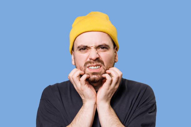 istock Suffering guy he has beard itch looking at camera in blue background studio portrait. 1463941306