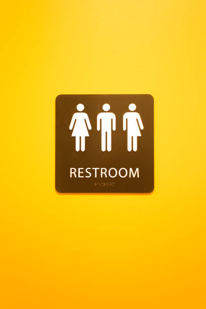 istock Gender Neutral Restroom Sign, Vibrant Yellow Background 1463945582