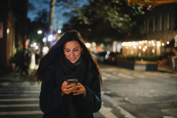 istock checking apps on the go in the evening walk 1463953295