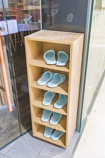 A shoe cabinet full of slippers