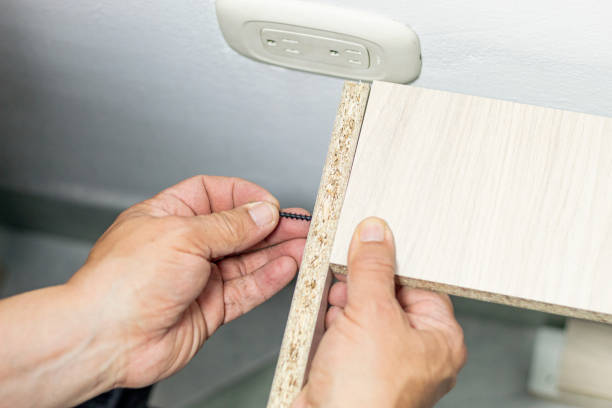 istock A man making a mark on a cabinet with a screw 1463963670
