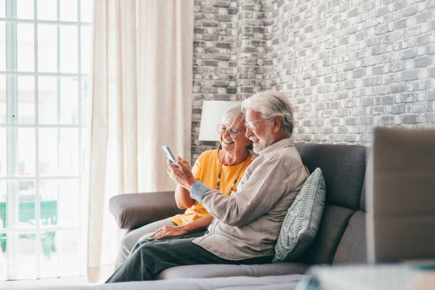 istock Elderly grandfather and grandmother spend time having fun using smartphone apps, middle-aged wife enjoy online entertainments, taking selfie with old husband, older generation and modern tech concept 1463964143