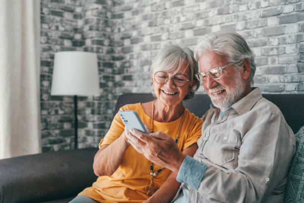 istock Elderly grandfather and grandmother spend time having fun using smartphone apps, middle-aged wife enjoy online entertainments, taking selfie with old husband, older generation and modern tech concept 1463964204