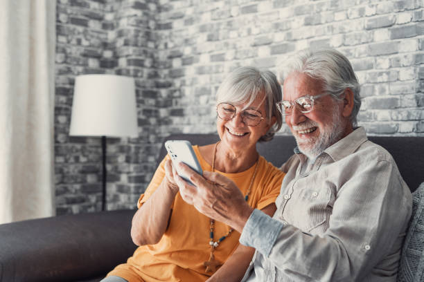 istock Elderly grandfather and grandmother spend time having fun using smartphone apps, middle-aged wife enjoy online entertainments, taking selfie with old husband, older generation and modern tech concept 1463965304