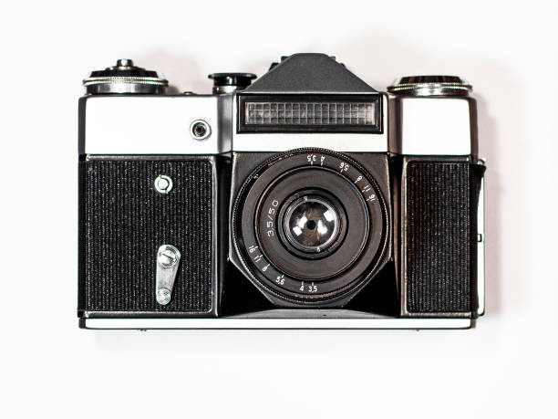 istock An old camera lies on a white background in a brown wooden frame 1463970458