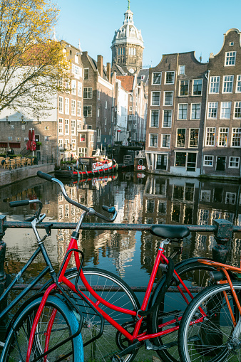 Riding bikes along canal in Amsterdam.