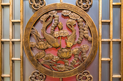 Old wooden door with animals and flower sculpture.