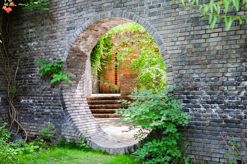 Arch in a wall made from red bricks.