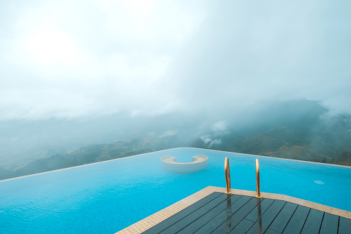 relaxing at infinity pool with beautiful nature landscape  mountains in Sapa, Vietnam