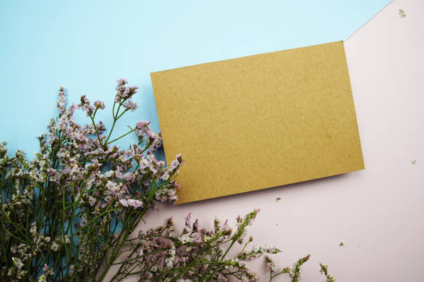 istock Empty invitation card mockup with flower bouquet on pink and blue background 1463990139