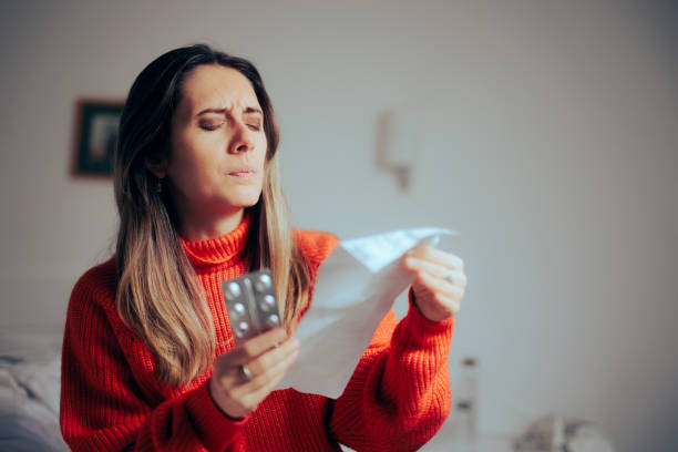 Woman Reading Medicine Information Leaflet Written in Small Letters stock photo