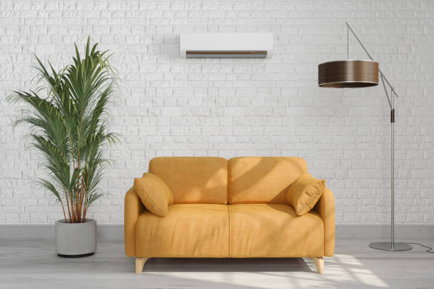 interior moderno da sala de estar com ar condicionado, sofá amarelo, candeeiro de pé e planta em vaso - air conditioner window heat hot day - fotografias e filmes do acervo