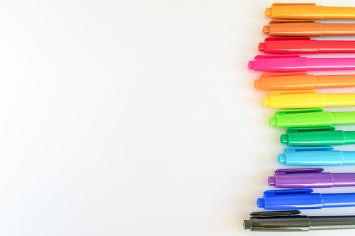 Colorful color pens lined up in a wavy pattern