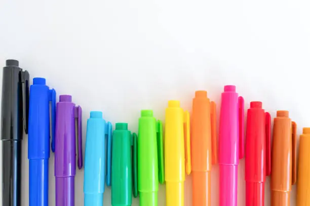 Colorful color pens lined up in a wavy pattern
