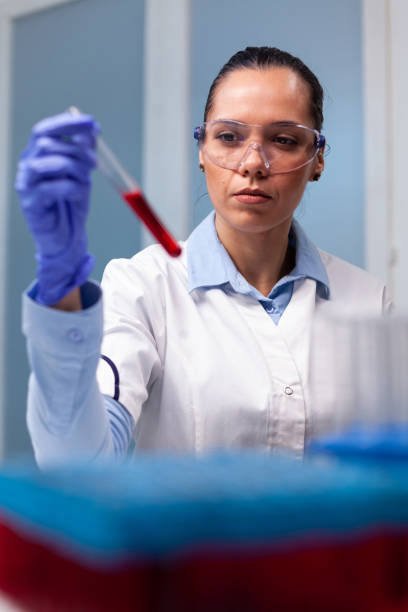 istock Specialist chemist analyzing blood test tube working at biochemistry experiment 1464004974