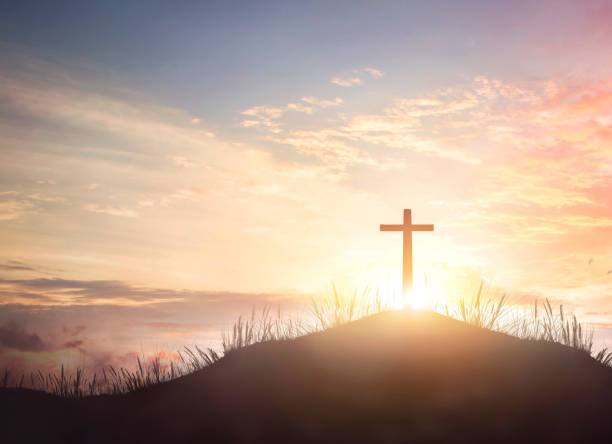 istock Wooden cross against orange sunrise 1464009303