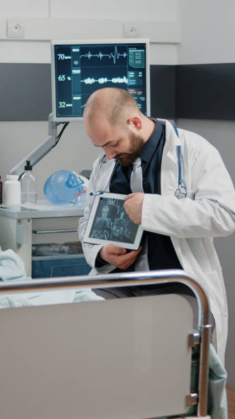 istock Medic pointing at tablet display with radiography for ill woman 1464016500