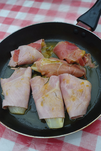 Endives and fennel wrapped in ham and sautéed in orange juice  French cuisine