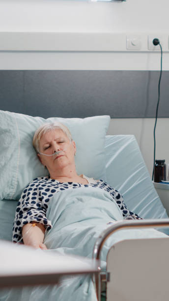 istock Aged patient with illness resting in hospital ward bed 1464017671