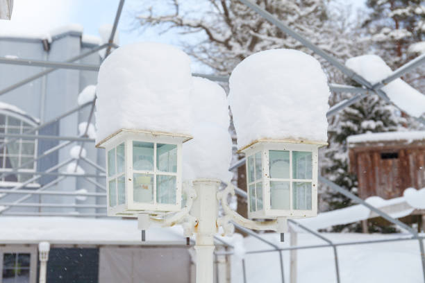 White vintage lanterns covered by snow