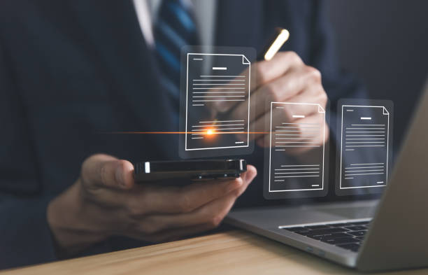 istock business people using smartphones working in front of laptop Handling electronic documents paperless office 1464020023