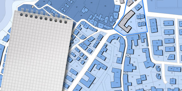 istock Imaginary cadastral map of territory with buildings, roads, land parcel and notepad with copy space 1464020949