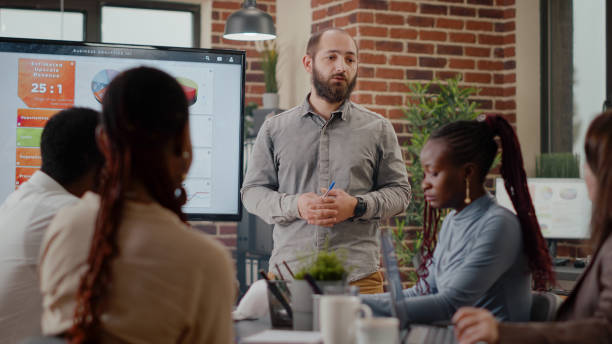 istock Close up of worker presenting business strategy on display 1464022155