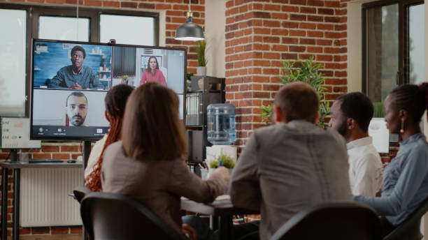 istock Workmates attending business meeting on online video call 1464022176