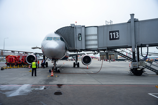 Moscow, Russia - August 08, 2022: Aircraft parked at Domodedovo airport terminal gate with connected passenger boarding bridge