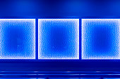 The texture of the wall is illuminated by blue lights