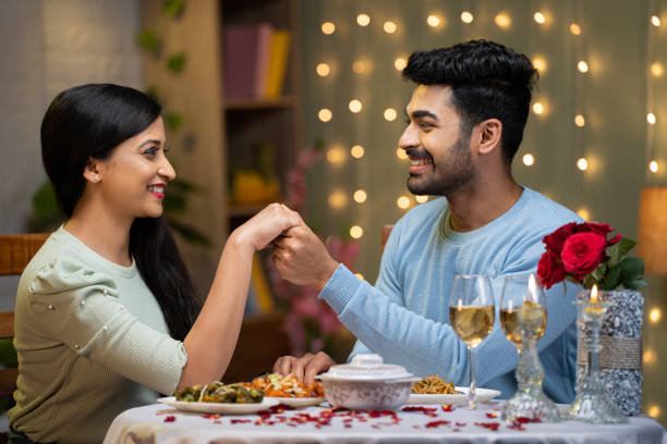 istock young man proposing to girlfriend by holding hands while arranging candlelight dinner - concept of love or emotion, valentine day and romantic couple 1464025872