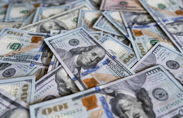 istock One hundred US dollars banknotes. United States Dollar bills. 1464025918
