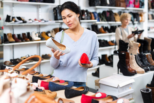 istock Focused Asian woman chooses ballet flats 1464025931