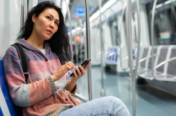 istock Woman passenger using phone in subway car 1464026200