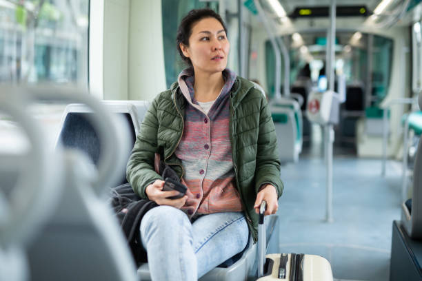 istock Asian woman with backpack sitting on seat inside tram at day 1464026500