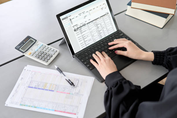 istock Asian woman entering journal entries in accounting software 1464028947