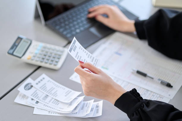 istock Asian woman entering expenses in accounting software 1464029061