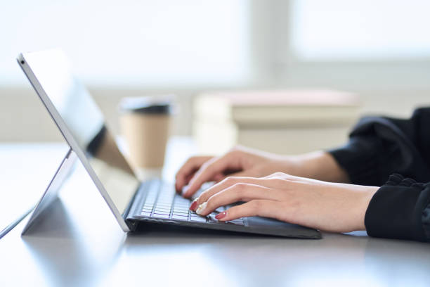 istock Asian woman typing on laptop 1464029068