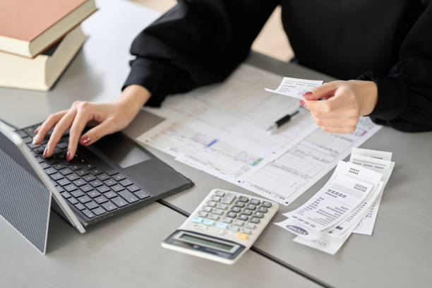 istock Asian woman entering expenses in accounting software 1464029177