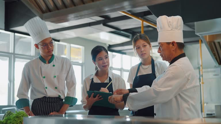 Chef training his student in cooking class